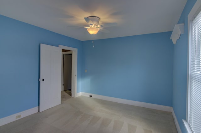 unfurnished bedroom featuring ceiling fan and light carpet