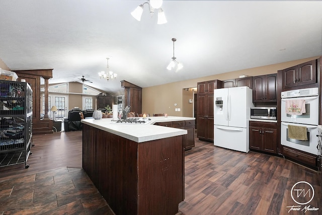 kitchen with white appliances, ceiling fan with notable chandelier, dark wood-type flooring, decorative light fixtures, and lofted ceiling