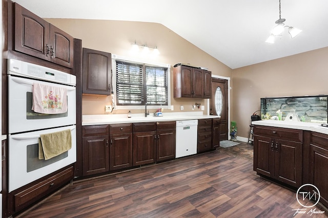 kitchen with white appliances, vaulted ceiling, dark wood-type flooring, and sink