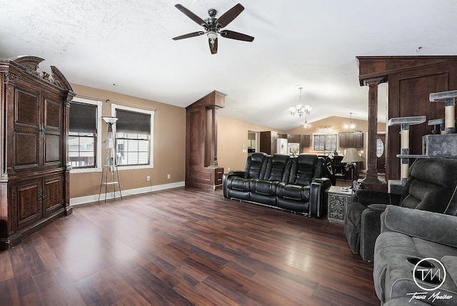 living room with a textured ceiling, ceiling fan with notable chandelier, dark hardwood / wood-style floors, and vaulted ceiling