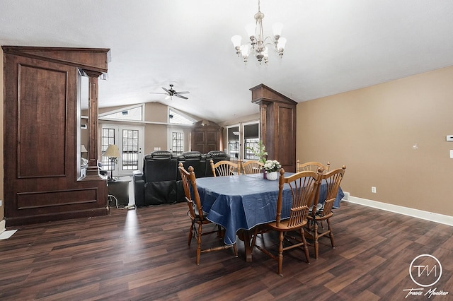 dining space with ornate columns, ceiling fan with notable chandelier, dark wood-type flooring, and vaulted ceiling