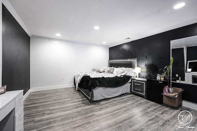 bedroom featuring light wood-type flooring and ornamental molding