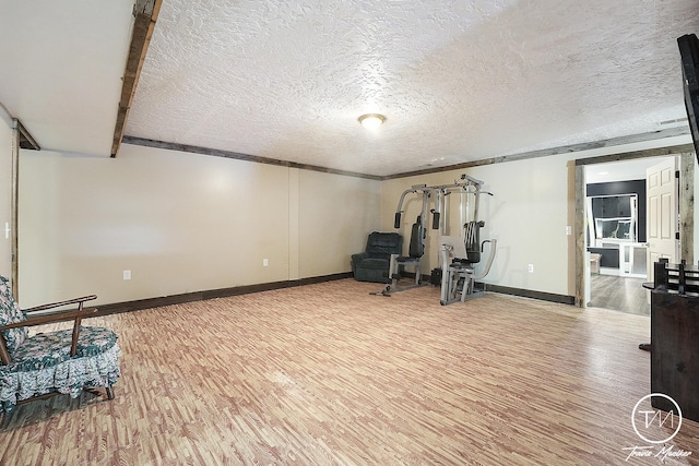 workout area featuring a textured ceiling and hardwood / wood-style flooring