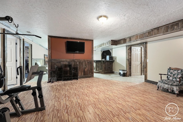 living room featuring wood-type flooring and a textured ceiling