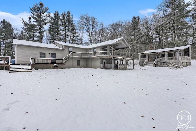 snow covered house with a deck