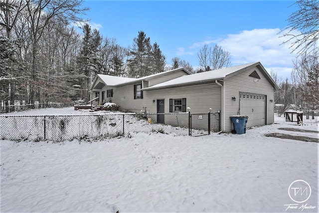 view of snowy exterior with a garage