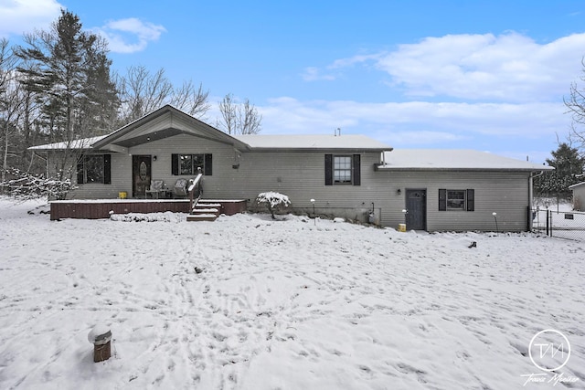 view of snow covered back of property