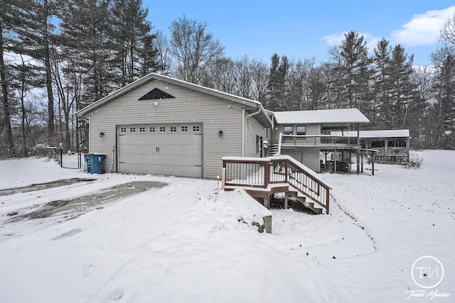 view of front of house with a garage and a wooden deck