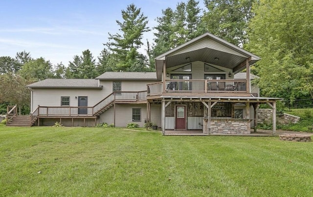 rear view of property featuring a deck and a lawn