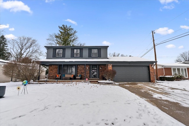 front of property featuring covered porch and a garage