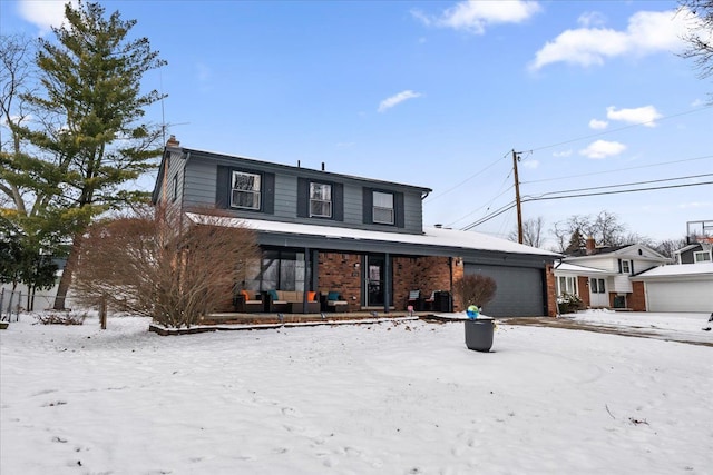 view of property featuring a porch and a garage