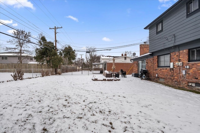 view of yard layered in snow