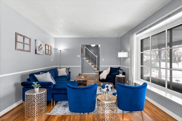 living room with a textured ceiling and hardwood / wood-style flooring