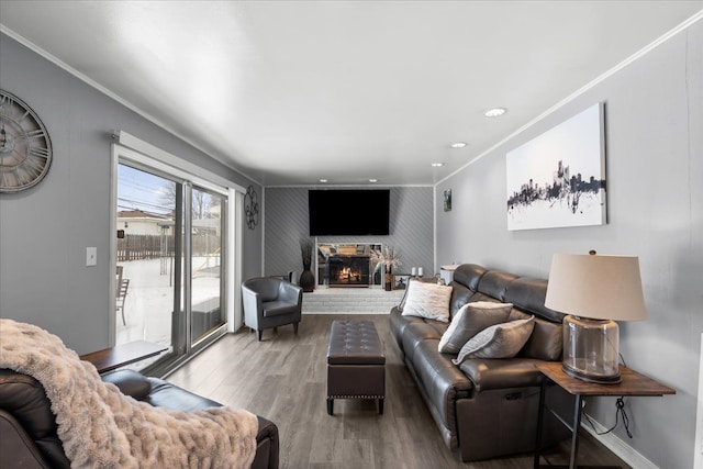 living room with hardwood / wood-style flooring and crown molding