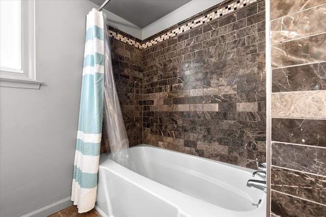 bathroom with shower / bathtub combination with curtain