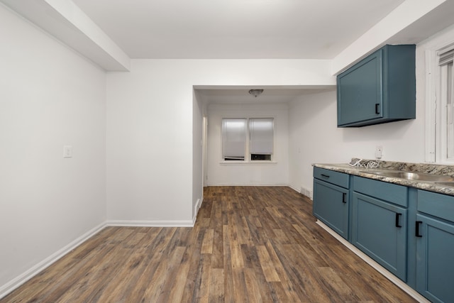 kitchen featuring blue cabinetry and dark hardwood / wood-style floors