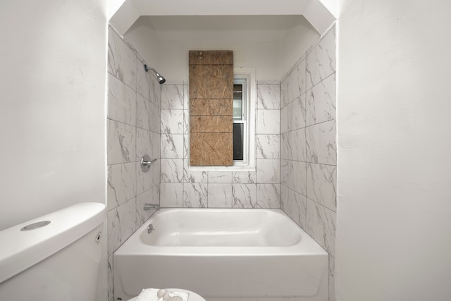 bathroom featuring tiled shower / bath and toilet