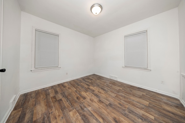 unfurnished room with dark hardwood / wood-style floors