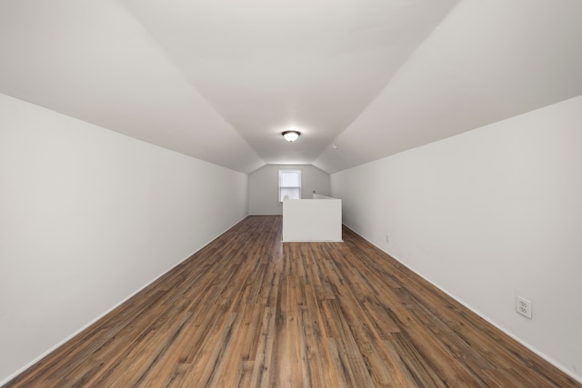 bonus room featuring lofted ceiling and dark wood-type flooring