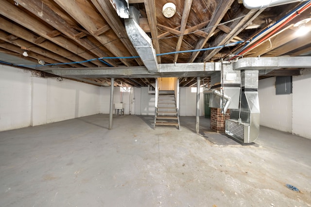 basement with heating unit and sink