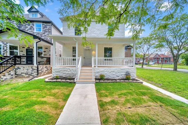 view of front of home with a front yard and a porch