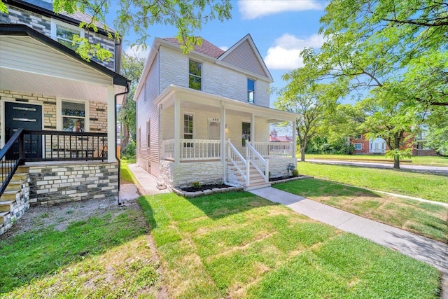 view of front of home featuring covered porch and a front yard