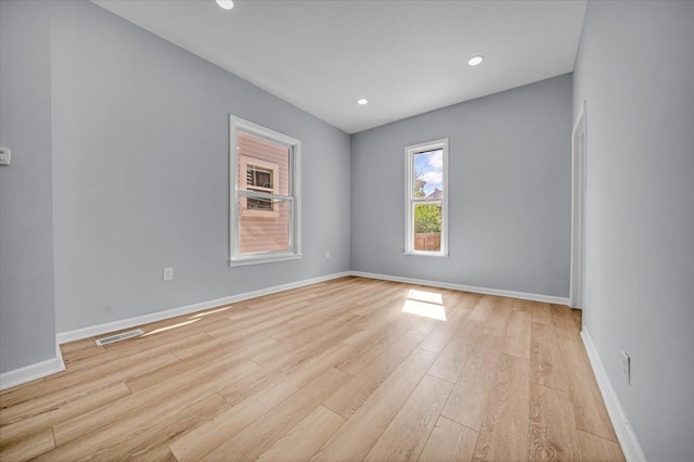 spare room featuring light wood-type flooring