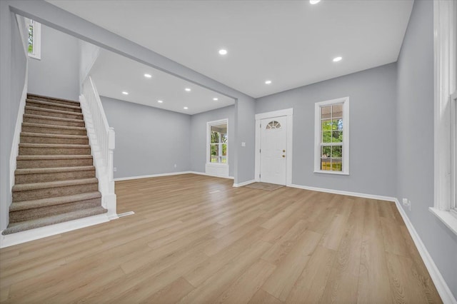 unfurnished living room featuring a healthy amount of sunlight and light wood-type flooring