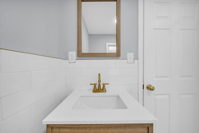 bathroom with vanity and tile walls