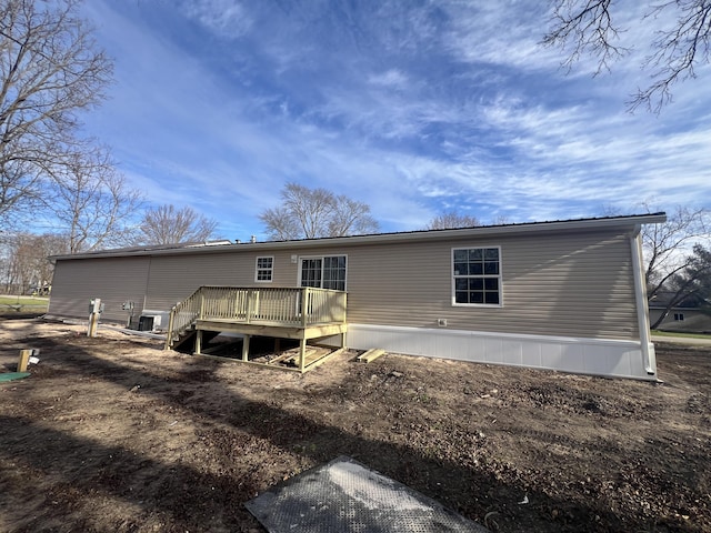 back of property with a wooden deck