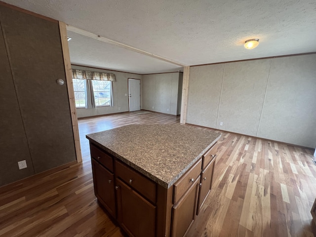 kitchen featuring hardwood / wood-style floors and a textured ceiling