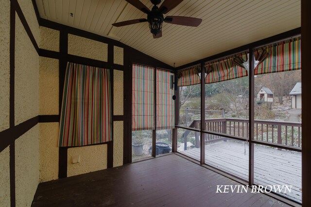 unfurnished sunroom featuring lofted ceiling, wood ceiling, and ceiling fan