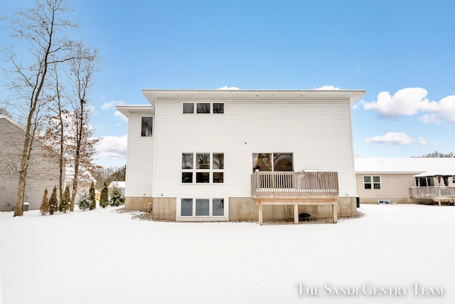 view of snow covered rear of property