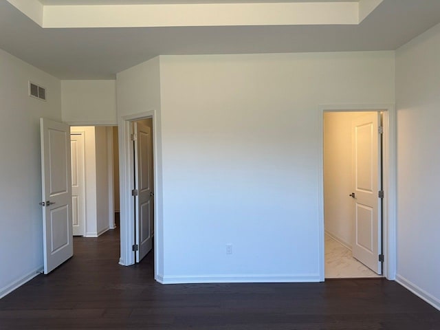 unfurnished room with dark hardwood / wood-style flooring