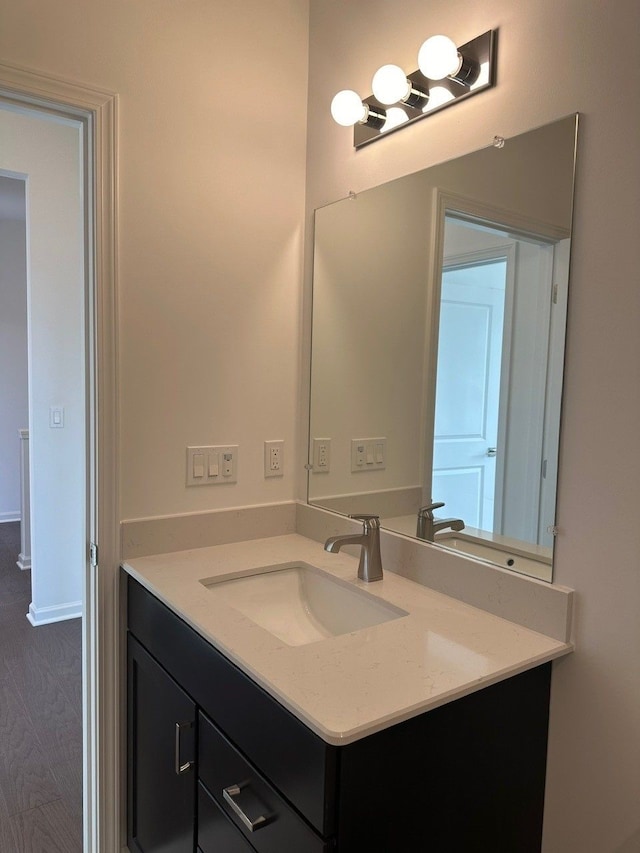 bathroom with hardwood / wood-style floors and vanity