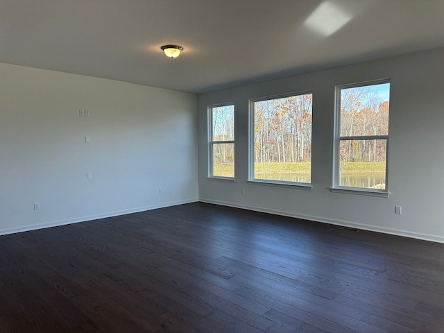 spare room featuring dark hardwood / wood-style flooring