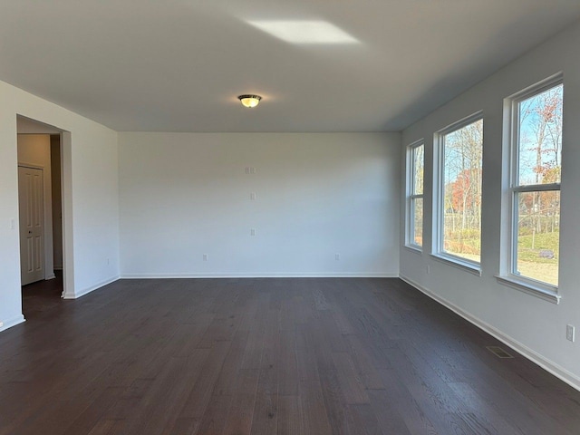 spare room featuring dark wood-type flooring