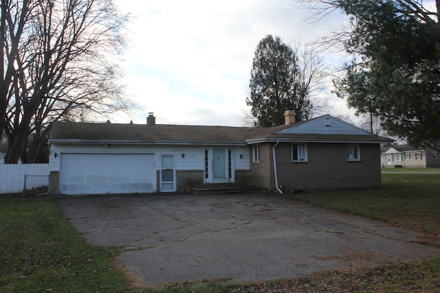 view of front of home featuring a garage and a front lawn