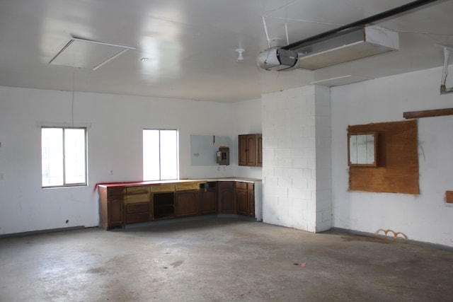 garage featuring electric panel and a garage door opener