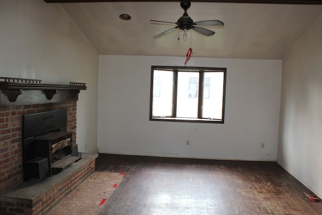 unfurnished living room with ceiling fan, dark wood-type flooring, and vaulted ceiling