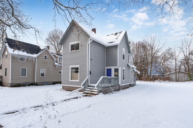 view of snow covered rear of property