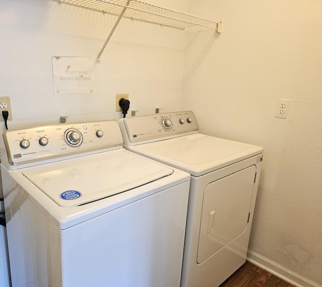 washroom featuring washing machine and dryer and dark hardwood / wood-style flooring