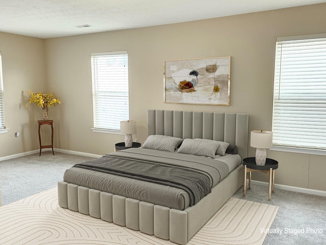 carpeted bedroom featuring a textured ceiling