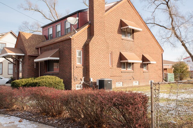 view of side of home with central air condition unit