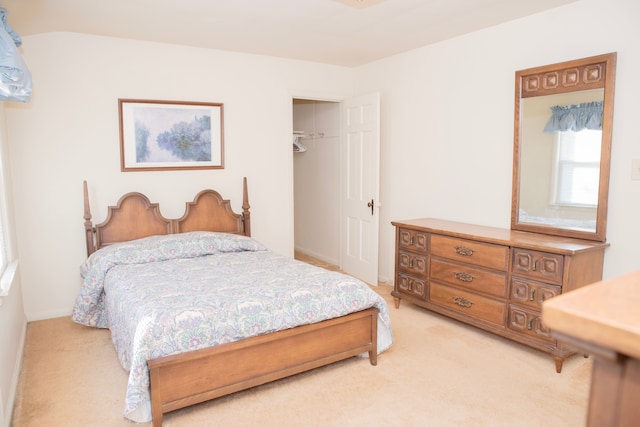 bedroom featuring light carpet and a closet