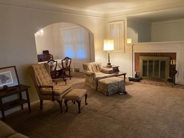 sitting room with carpet floors and a fireplace