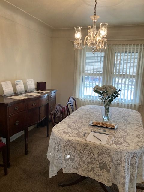 carpeted dining room with a chandelier