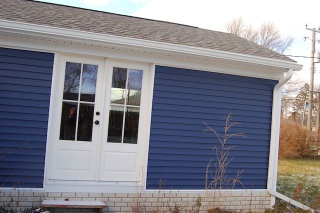 exterior space with roof with shingles