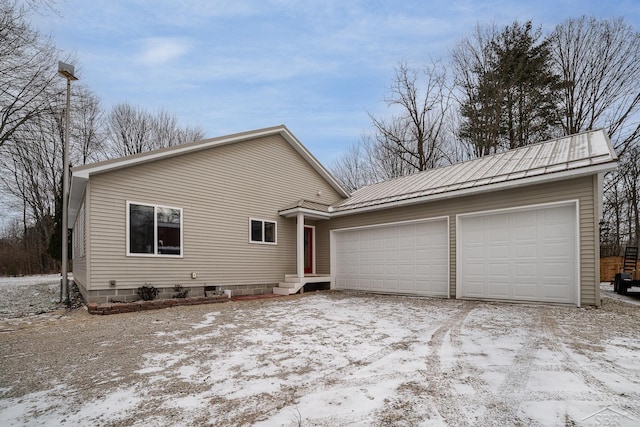 2565 S M 30th Rd, Beaverton, MI 48612 - view of front of home featuring a garage and a metal roof