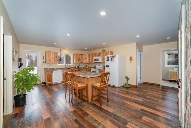 2565 S M 30th Rd, Beaverton, MI 48612 - kitchen with white appliances, dark wood-type flooring, recessed lighting, a center island, and light countertops